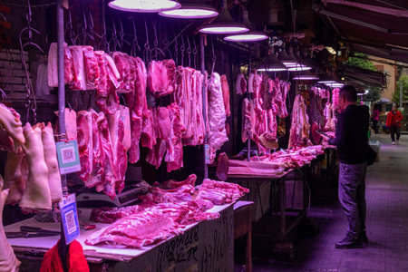 Chongqing, China- 2 Nov 2025: Butcher stall where porks are sold in Chongqing, China. Pork is widely available in Chongqing at local wet markets, as it is the most consumed meat in China.のeditorial素材