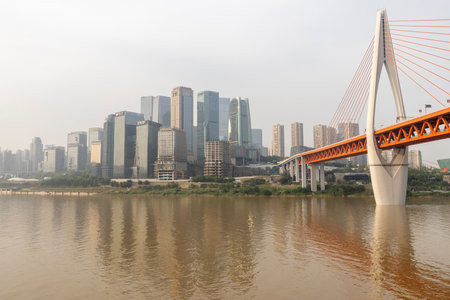 Chongqing, China- 2 Nov 2025: Overview of Qiansimen bridge where it cross the Jialing river in Chongqing, China. Qiansimen Bridge in Chongqing is a modern architectural marvelのeditorial素材