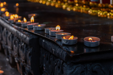 Burning candles in the Louhan Temple in Chongqing, China. Lighting candles or incense sticks symbolizes respect to the Buddha, prayers for peace, and the illumination of wisdomの写真素材