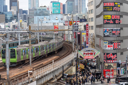 Tokyo, Japan- 27 Dec 2025: Ueno Ameyoko vibrant market scene with the Tokyo subway passing overhead...