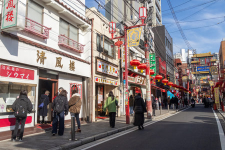 Yokohama, Japan- 23 Dec 2025: Vibrant street of Chinatown in Yokohama, Japan. It energetic streets filled with colorful gates and array of Chinese foods, creating a lively, bustling atmosphereのeditorial素材