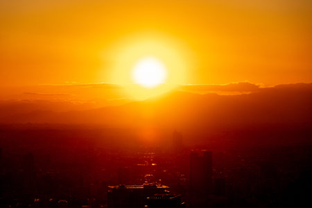 View of sunset in Tokyo. Watching the sunset offers a stunning panoramic transition from day to night over Tokyoの写真素材