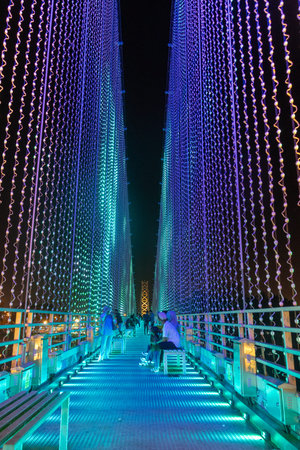Kuching, Malaysia- 28 Jan 2026: Satok Suspension Bridge in Kuching, Malaysia. With colored lights...