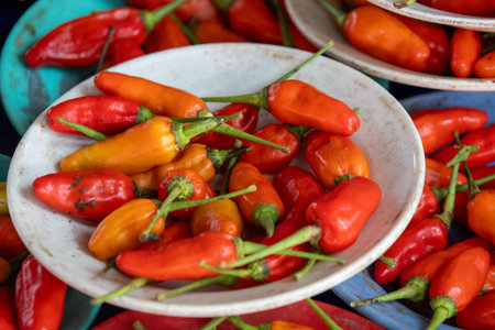 Red chili peppers sold on the local market in Kuching, Malaysia. They are often sold in small piles...