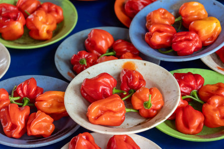 Chili peppers sold in Kuching, Malaysia. They are often sold in small piles and are usually red or...