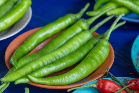 Green chili peppers sold on the local market in Kuching, Malaysia. They are often sold in small piles and are usually red or greenの写真素材