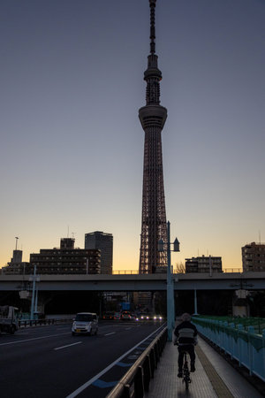 Tokyo, Japan- 17 Dec 2025: Silhouette of Tokyo SkyTree during the sunrise. It is a broadcasting and...