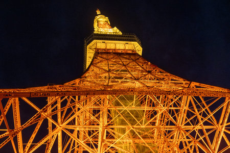Tokyo, Japan- 22 Dec 2025: Tokyo Tower light-up with warm orange color. Standing tall, it offers...
