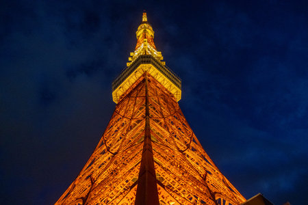 Tokyo, Japan- 22 Dec 2025: Tokyo Tower light-up with warm orange color. Standing tall, it offers...