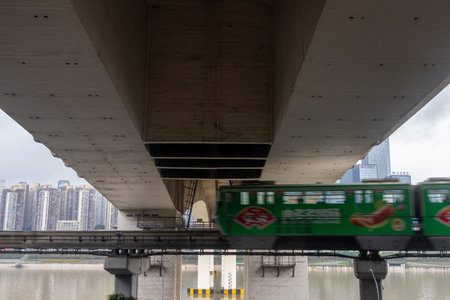 Chongqing, China- 7 Nov 2025: Chongqing metro passes through the bridge in Chongqing city, China....
