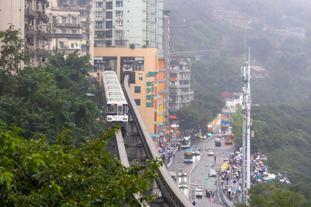 Chongqing, China- 7 Nov 2025: Chongqing metro train travel on the high rise track in Chongqing city, China. It serves the transportation needs of the city main business areas and inner suburbs.のeditorial素材