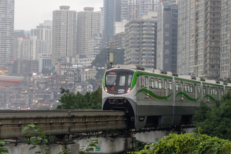 Chongqing, China- 7 Nov 2025: Chongqing metro train travel on the high rise track in Chongqing city,...