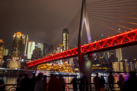Chongqing, China- 8 Nov 2025: Night view of Chongqing city in China with Qiansimen bridge and Hongyadong Scenic Area. It offering breathtaking views of Chongqing's multi-layered urban landscapeのeditorial素材