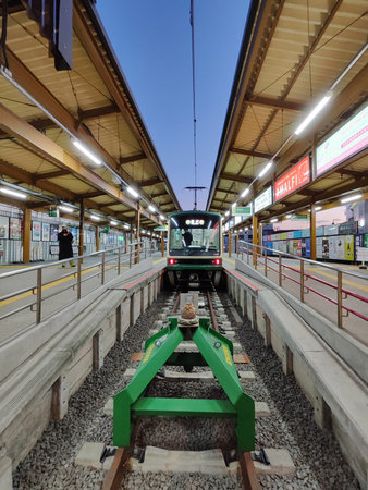 Kamakura , Japan-17 Dec 2025: Beautiful retro train for Enoden (Enoshima Electric Railway) stops at Kamakura station in Japan. The Enoden is the best way to get around prime sightseeing spotsのeditorial素材