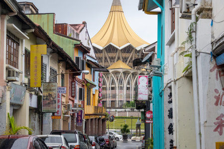 Kuching, Malaysia- 26 Jan 2026: View of Sarawak Legislative Assembly from a street with colonial shop houses in Kuching, Malaysia. It is a grand, spectacular structure on the banks of Sarawak Riverのeditorial素材