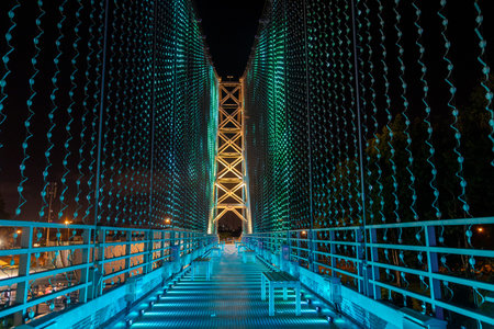 Kuching, Malaysia- 28 Jan 2026: Satok Suspension Bridge in Kuching, Malaysia. With colored lights...