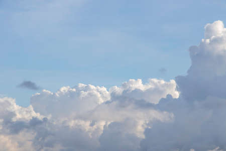 white fluffy clouds in the blue skyの写真素材