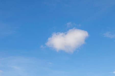 white fluffy clouds in the blue skyの写真素材
