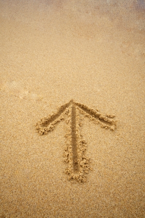 arrow on beach sandの写真素材