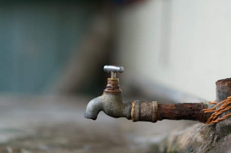 Dripping water faucet outdoorの写真素材