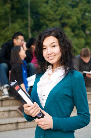 Asian Student with notepad on campusの写真素材
