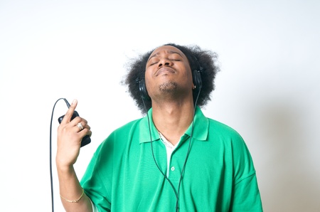 African American Teenager in green Shirt with listen to musicの写真素材