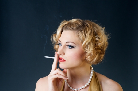beautiful blond woman smoking cigaretteの写真素材