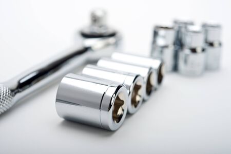 metal ratchet with sockets set on white backgroundの写真素材