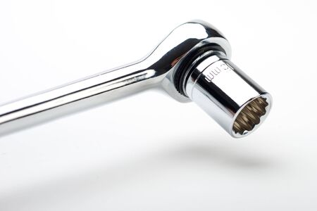 metal ratchet with socket set on white background