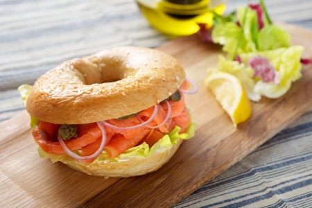 Salmon Bagel Sandwich on cutting boardの写真素材