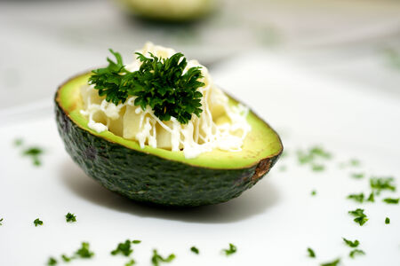 Beautiful avocado and vegetables in the plateの写真素材