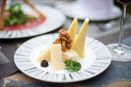 Gourmet Appetizers with various cheese on a tableの写真素材