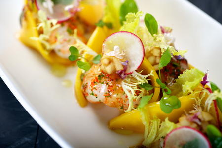 Colorful Lobster meat dish with vegetable garnishの写真素材