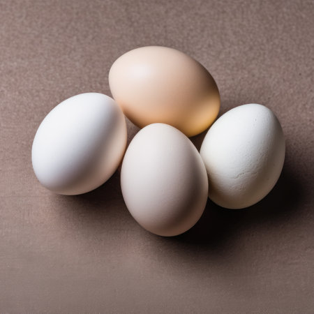 Three white eggs on a brown background. The concept of healthy food.の素材