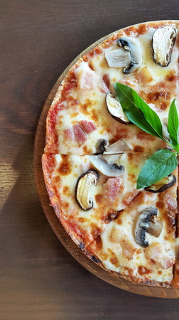 Half pan of Mushroom and Bacon Pizza on wood tableの写真素材