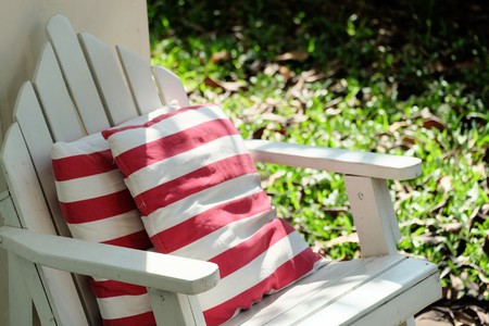 Relax white garden chair with red-white stripe pillowの写真素材