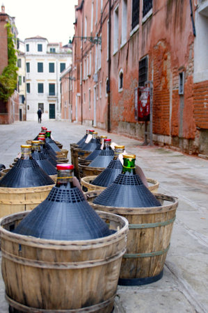 Delivering wine damigiane in Veniceの写真素材