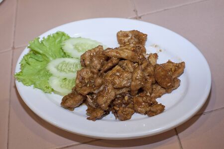 Pork with garlic and pepper decorated with vegetablesの写真素材