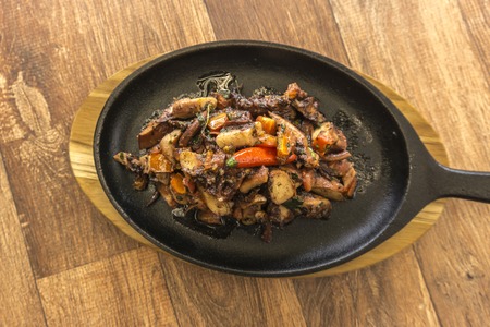 Grilled octopus with black skillet vegetables