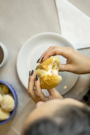 Close up top view of woman's hand holding sandwichの写真素材