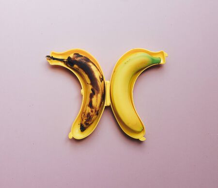 Yellow banana on the board. Healthy food. Composition of yellow objects. Perfect snack. Vegetarian vitamins food.の写真素材