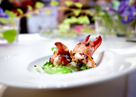 Festive meal. Restaurant lobster dish floral arrangement. Modern food for celebrationsの写真素材