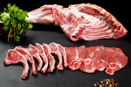Fresh and raw meat. Uncooked ribs and pork chops, ready to grill and barbecueの写真素材