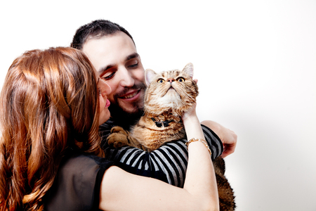 Young couple with their cat at home Couple, pets.animalsの写真素材