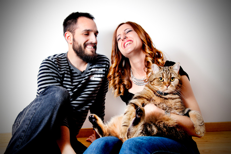 Young couple with their cat at home Couple, pets.Lifestileの写真素材