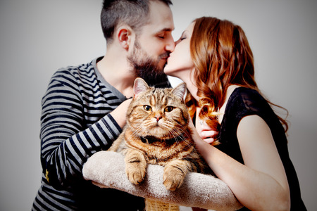 Young couple with their cat at home Couple, pets. animalsの写真素材