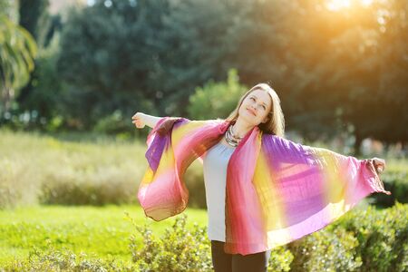 woman relaxing with open arms and smilingの写真素材