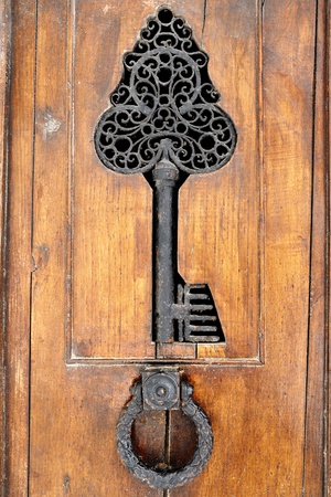 detail and knocker of a vintage wooden doorの写真素材