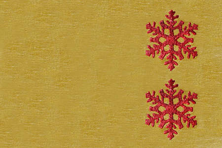 two red Christmas tree decoration on golden backgroundの写真素材