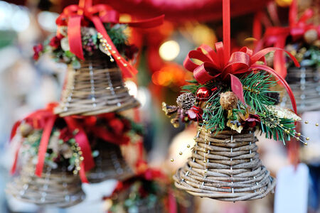 Christmas tree decoration bell with red ribbon and ornamentsの写真素材